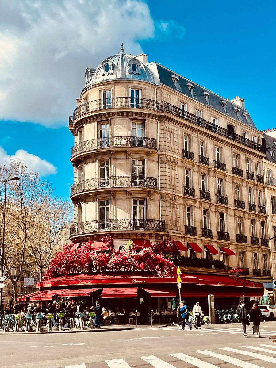 An elegant Parisian corner brasserie with red awnings