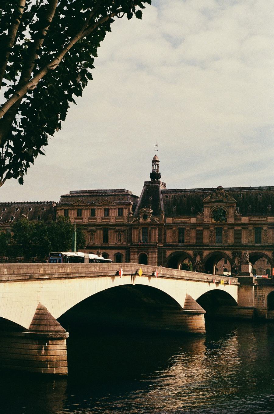 A bridge over the Seine with the Louvre behind